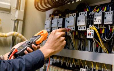 Electrician engineer work  tester measuring  voltage and current of power electric line in electical cabinet control.